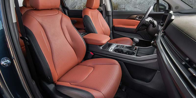 Interior of a car featuring orange leather seats and a modern dashboard.