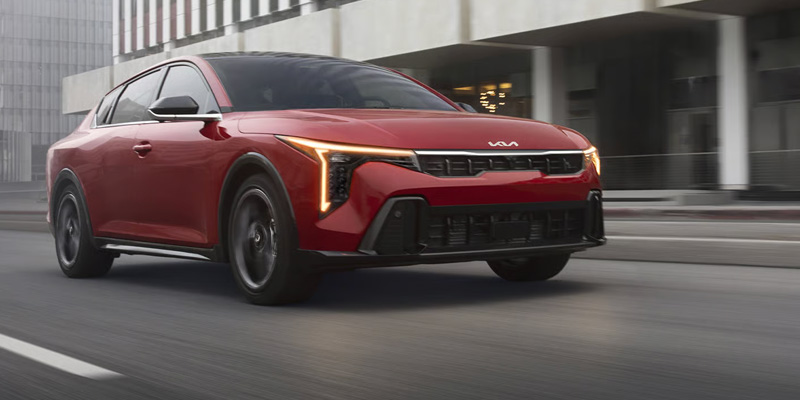Red 2026 Kia K4 on road